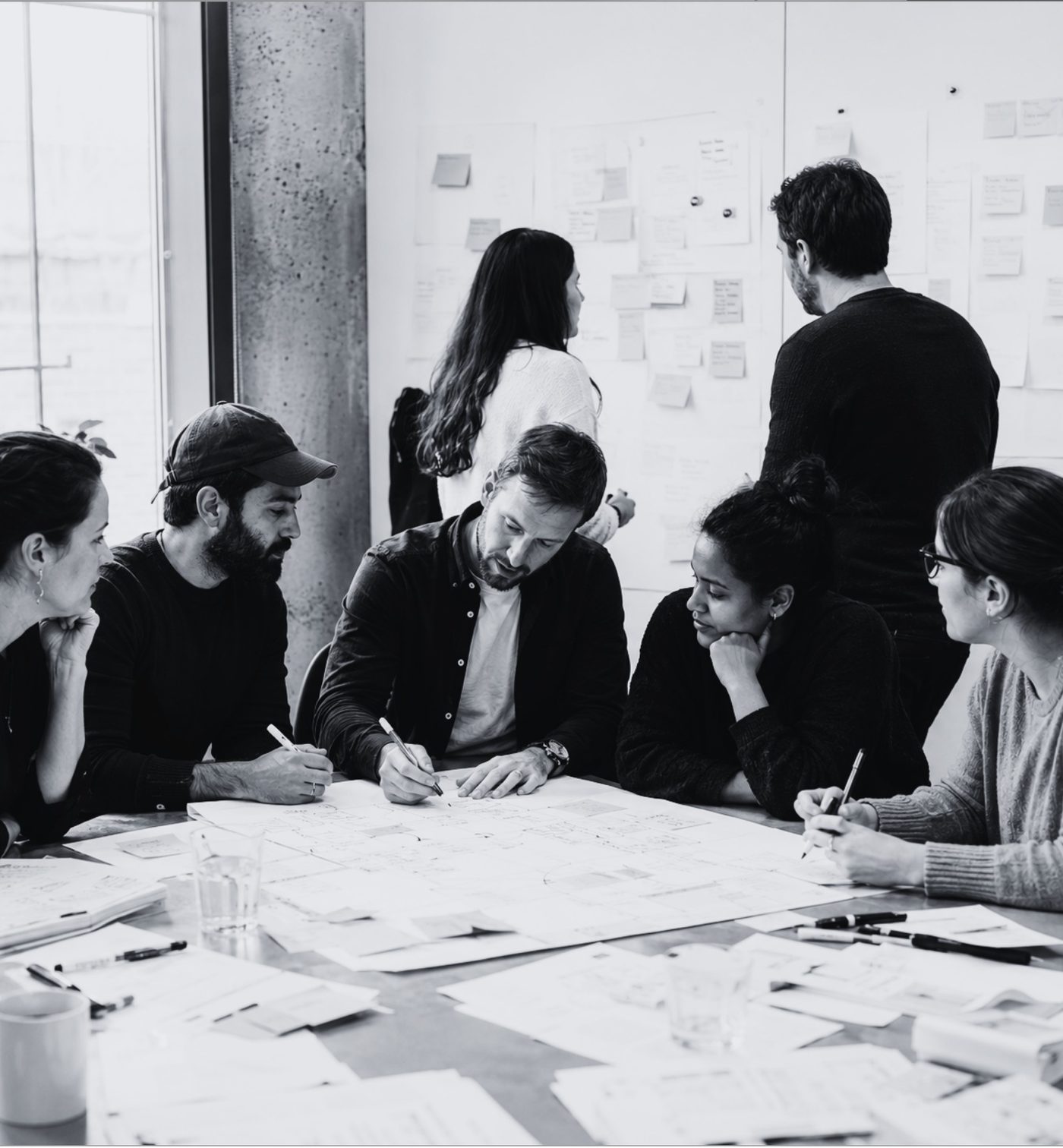Team workshopping change plans with sticky notes