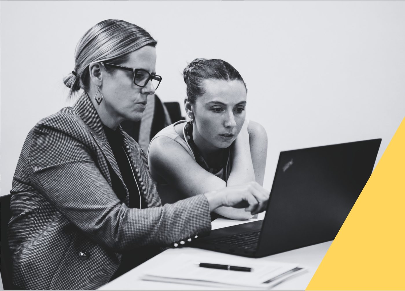 Colleagues reviewing change materials on a laptop