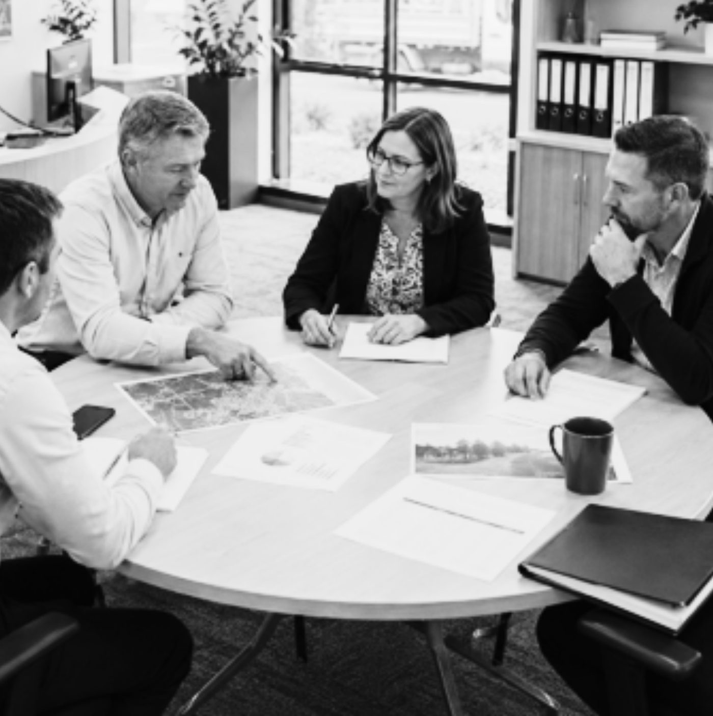 Executives reviewing plans around a table